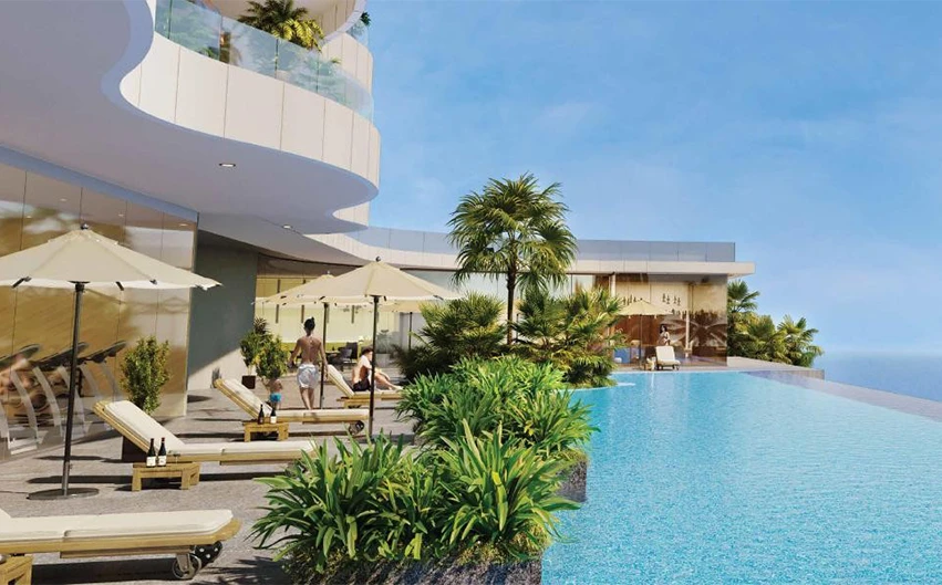 Residents enjoying luxury amenities at beachfront 
